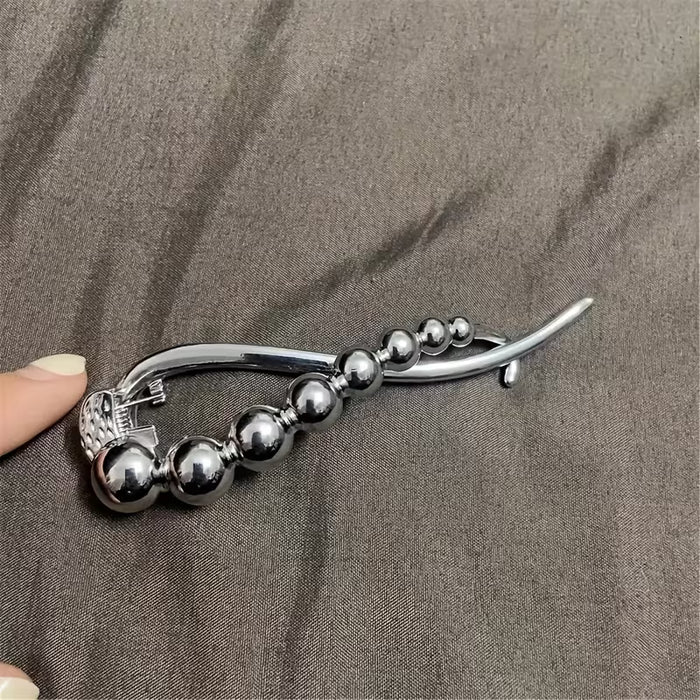 Pinza para el cabello con giro de pedrería