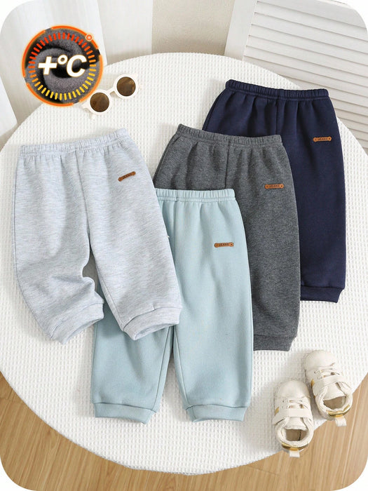 Shein 4 piezas de pantalones deportivos casuales de color liso con cintura elástica para niño