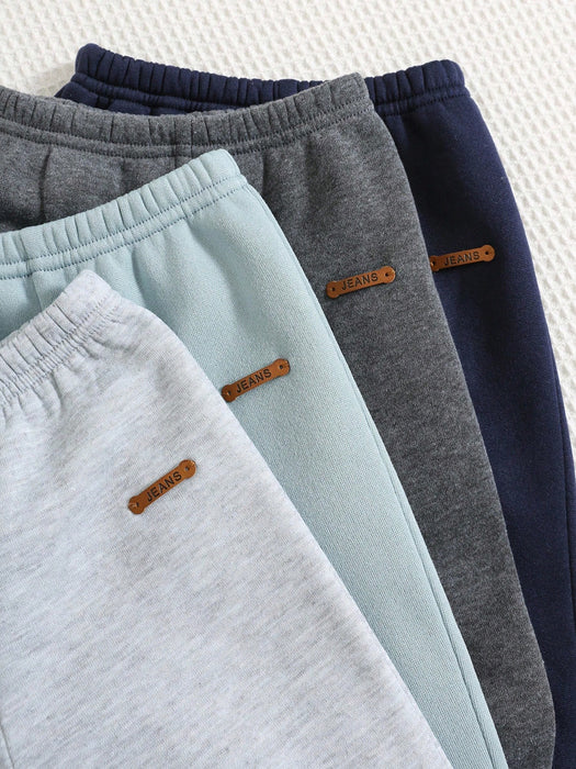 Shein 4 piezas de pantalones deportivos casuales de color liso con cintura elástica para niño