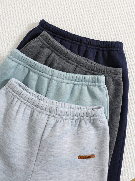 Shein 4 piezas de pantalones deportivos casuales de color liso con cintura elástica para niño