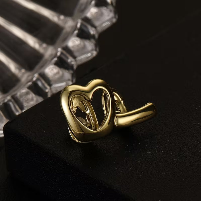 Shein Grillz de cobre en forma de corazón con diseño de rayas de amor huecas, acabado dorado