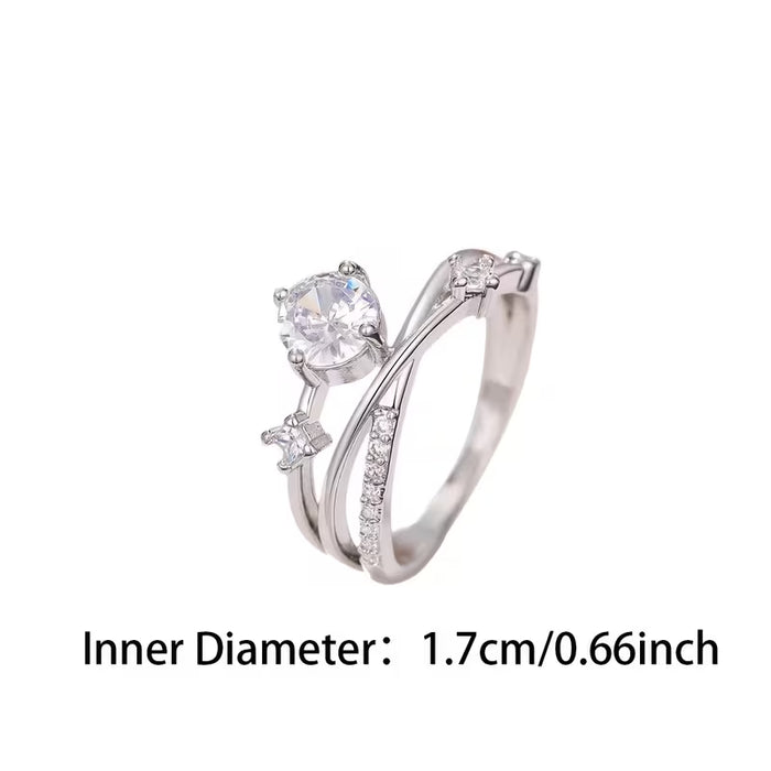 Anillo con bandas entrecruzadas y circonita sintética central, diseñado para mujer.
