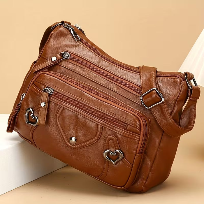 Un elegante bolso bandolera para mujer con múltiples bolsillos, de color sólido de cuero sintético