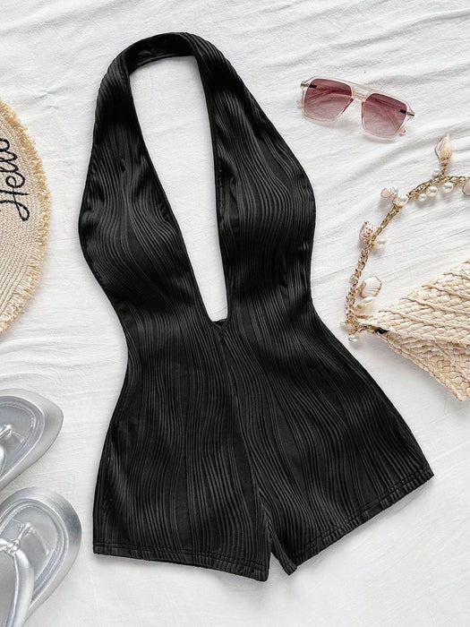 Body de punto blanco con textura y patrón ondulado, escote en V profundo y espalda descubierta