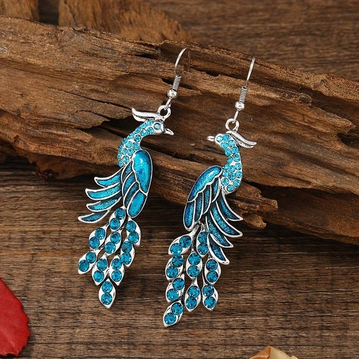 Shein Un par de pendientes colgantes modernos para mujer con diseño de pavo real