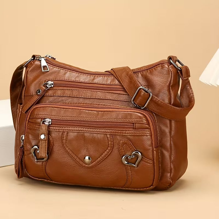 Un elegante bolso bandolera para mujer con múltiples bolsillos, de color sólido de cuero sintético