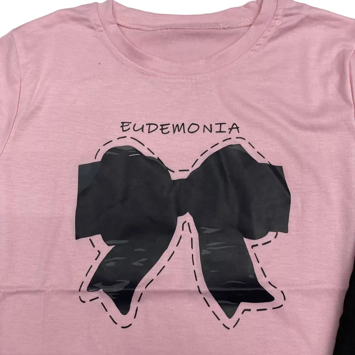 Conjunto de  camisa rosa con lazo y pantalones acampanados negros para niñas