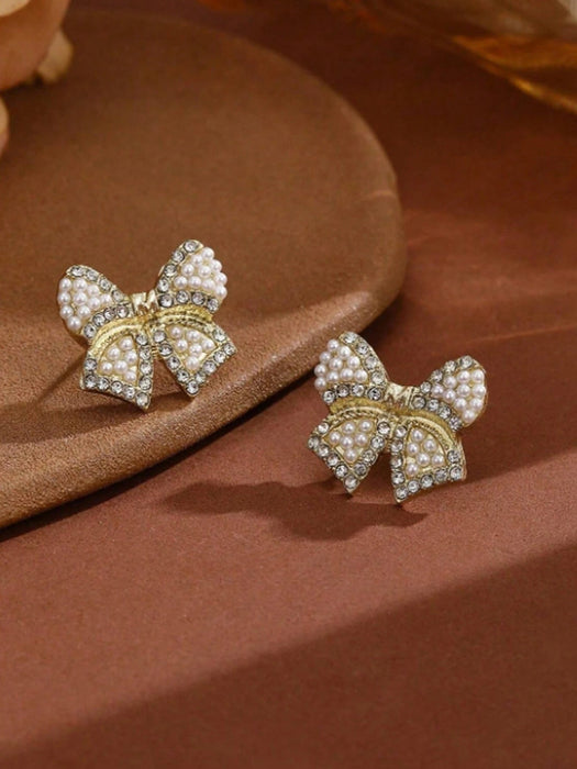 Shein 1 par de pendientes de lazo de resina con perlas artificiales en color dorado - Quierox - Tienda Online