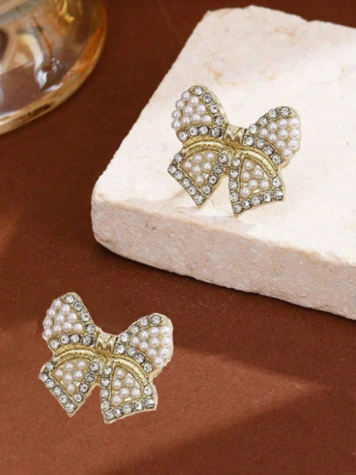 Shein 1 par de pendientes de lazo de resina con perlas artificiales en color dorado - Quierox - Tienda Online