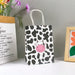 SHEIN 12 piezas Bolsa de regalo de papel en forma de mano con patrón de vaca de dibujos - Quierox - Tienda Online