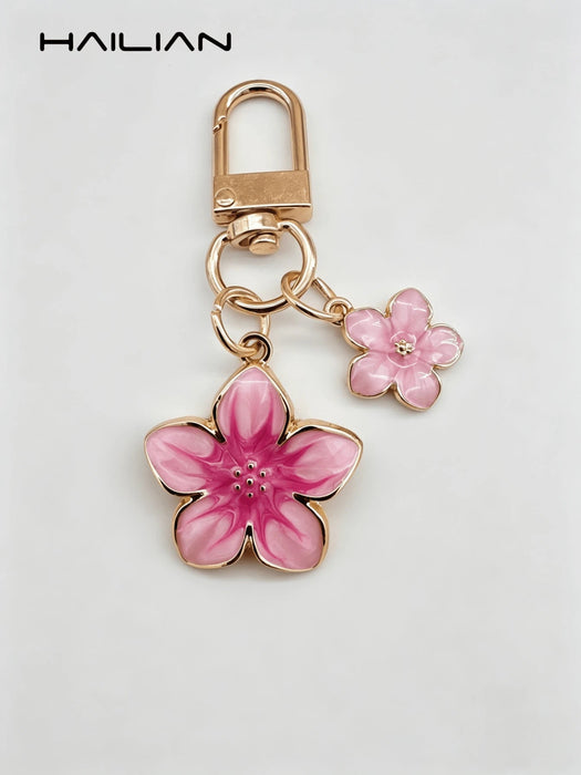 SHEIN HAILIAN 1 pieza Llavero con colgante en forma de flor de sakura de aleación ligera - Quierox - Tienda Online