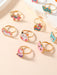Shein Juego de 12 anillos de aleación de zinc con forma de gota de aceite para niñas ajustables - Quierox - Tienda Online